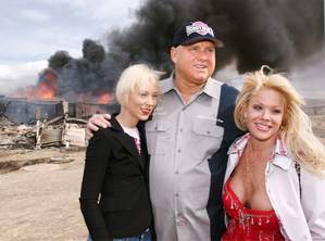 Moonlite Bunnyranch brothel owner Dennis Hof poses with two of his 